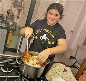 student cooking food for host family in Germany
